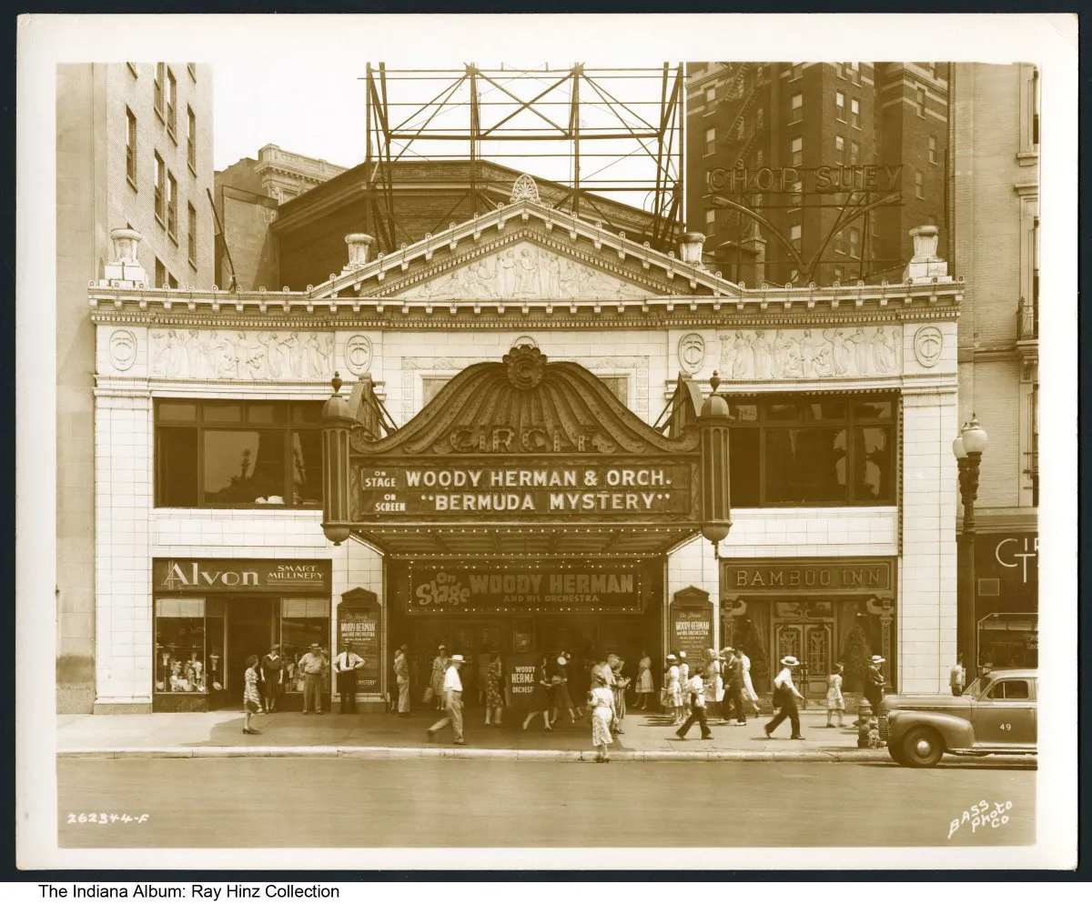 A sepia tone photo of the Circle Theatre, a two-story building with Neoclassical architecture and a large marquis. On the right side of the theatre entry is the Bamboo Inn.