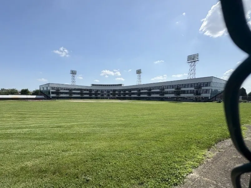 Former stadium seating is filled in with three stories of apartments at Stadium with balconies overlooking the former baseball field below